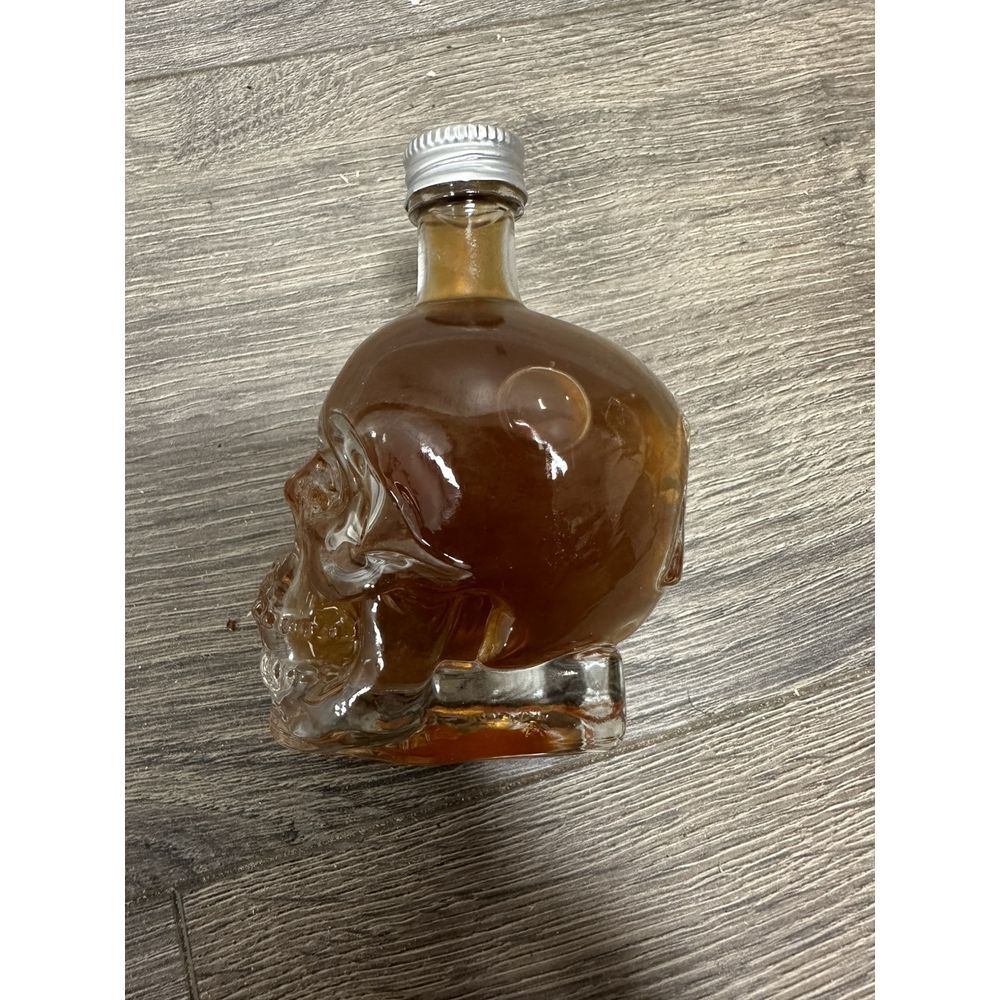 Glass Skull Apothecary With Liquid In It